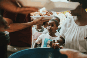 "Volunteers giving food donation for orphanage near me to children"