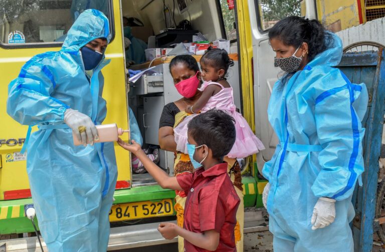 Volunteers from Dayitwa NGO activities are packing donation boxes with essential supplies while wearing masks and gloves during a community relief effort.